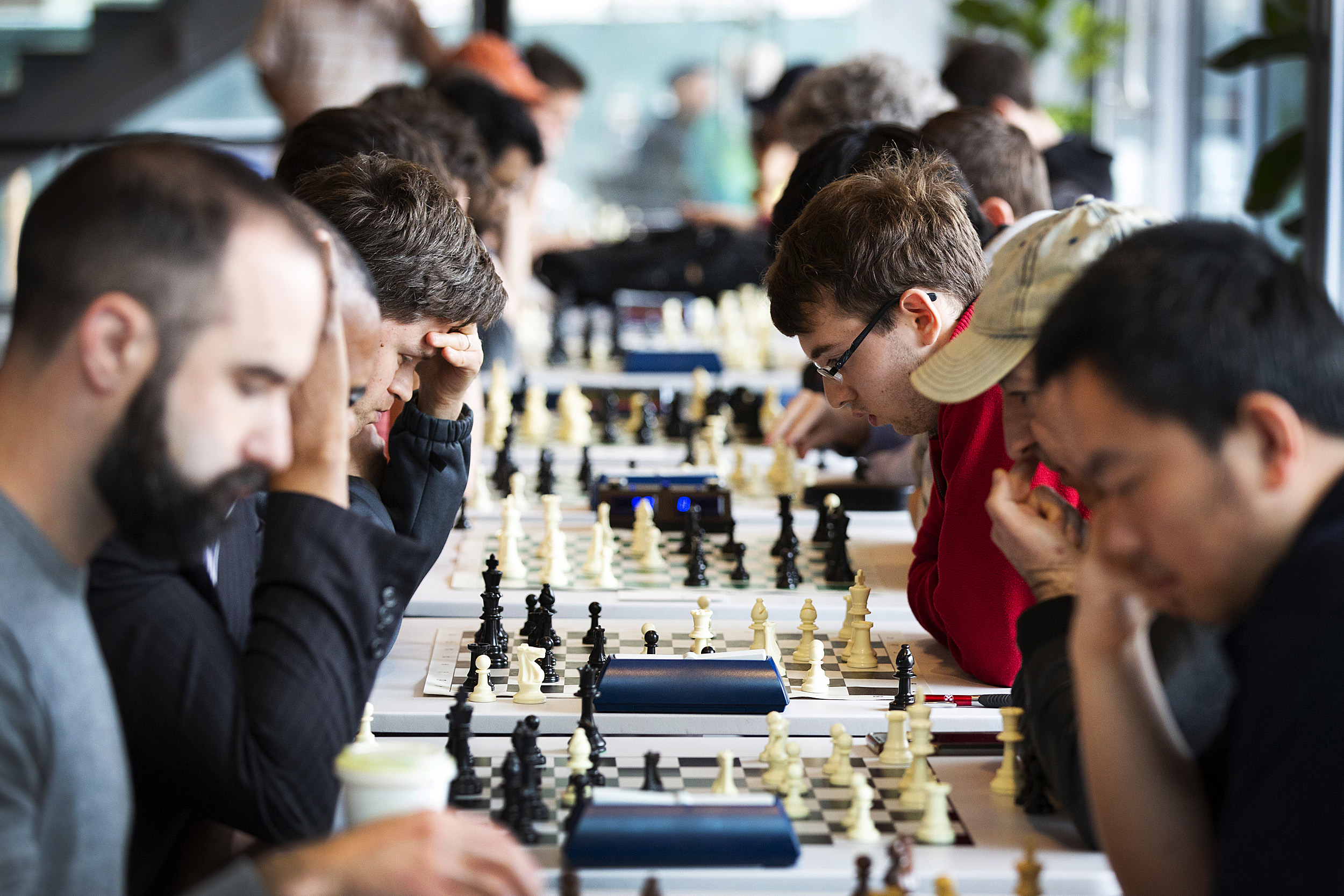 People competing in a chess tournament
