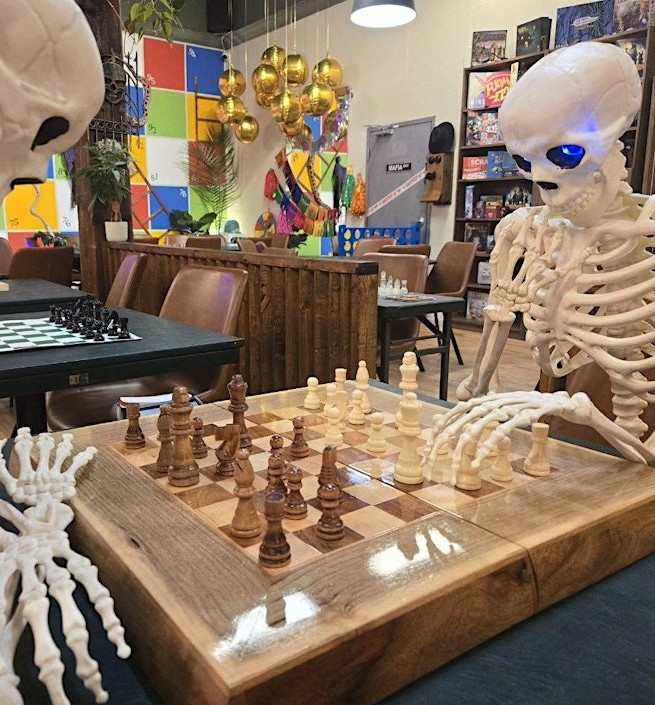 Two spooky skeletons playing chess